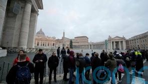 Doors open for thousands to see Pope Benedict’s body lying in state at Vatican