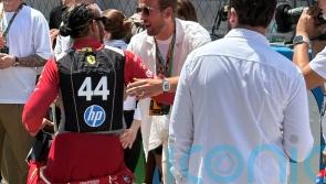 Harry Kane greets Lewis Hamilton as England players take in Spanish Grand Prix