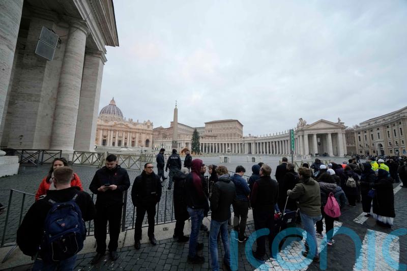 Doors open for thousands to see Pope Benedict’s body lying in state at Vatican