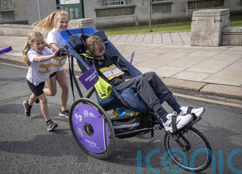 Rob Burrow pushed around Leeds fun run course by daughters on Father’s Day