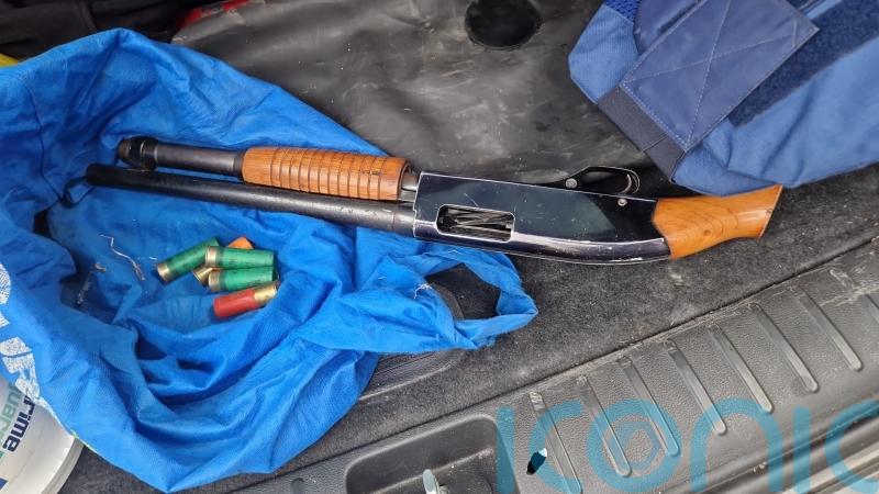 Two arrested and shotgun seized after suspect flees from car