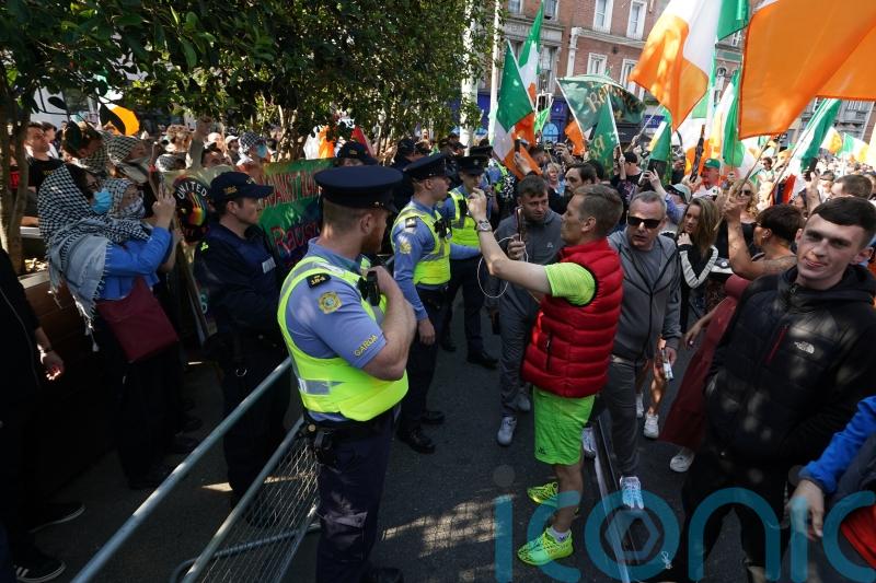 Gardai move in to disperse sit-down anti-immigration protest on Dublin bridge