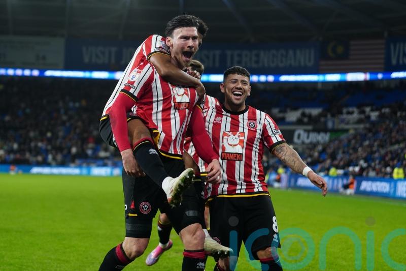 Kieffer Moore’s double at Cardiff maintains Sheffield United’s three-point lead