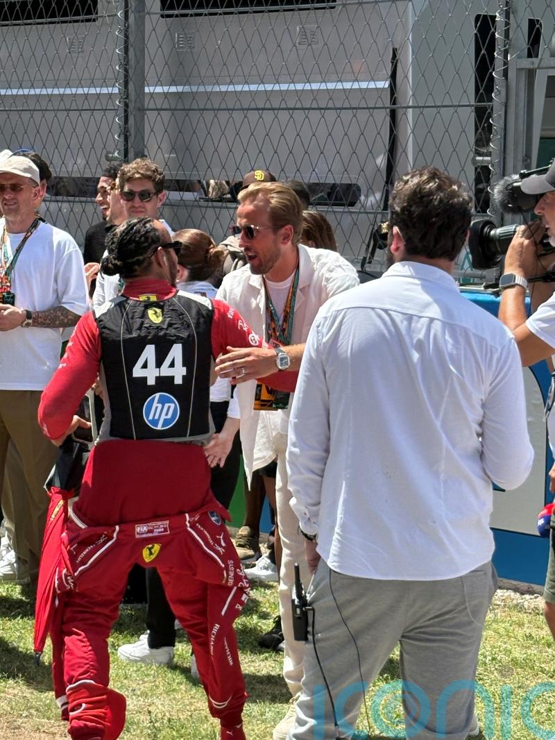 Harry Kane greets Lewis Hamilton as England players take in Spanish Grand Prix