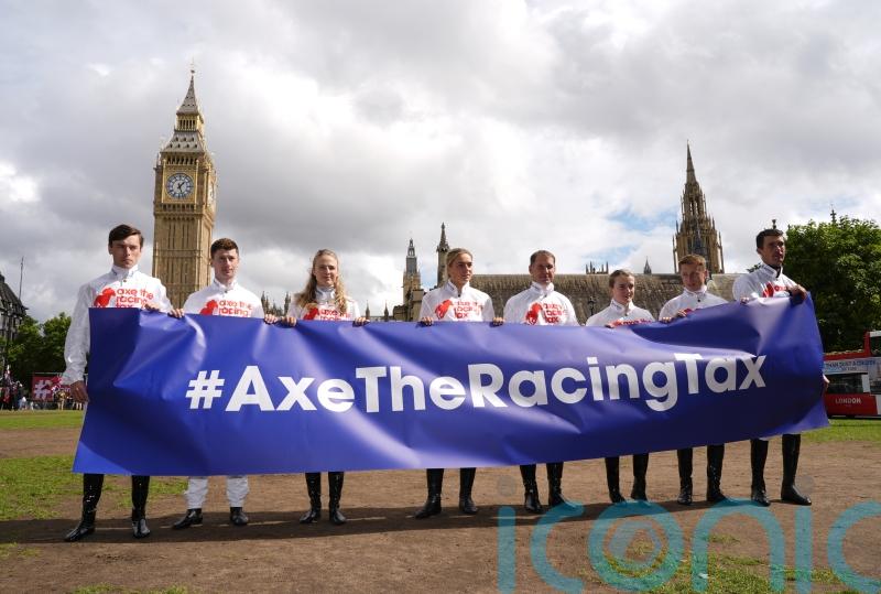 Hollie Doyle and Oisin Murphy stand together in Parliament Square, with racing on strike